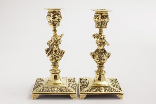 A stunning pair of Tudor Bust brass candlesticks