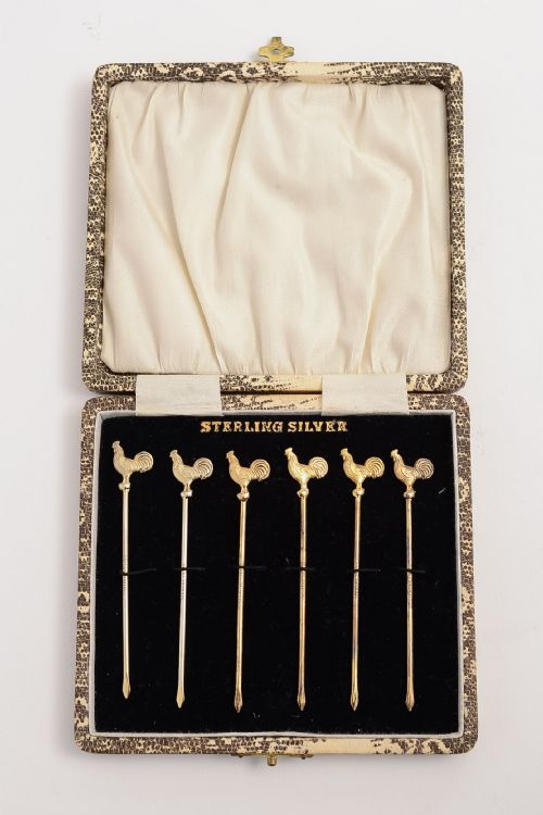 Boxed set of marked sterling silver cocktail sticks.