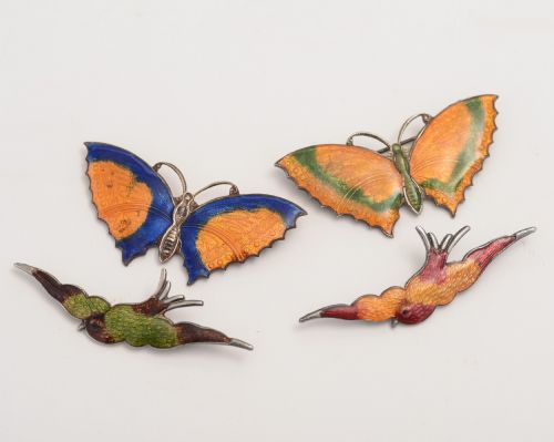 Collection of four enamel brooches.