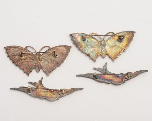 Collection of four enamel brooches.