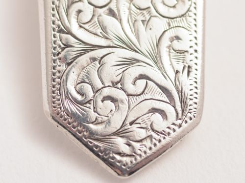 A silver shell shaped caddy spoon