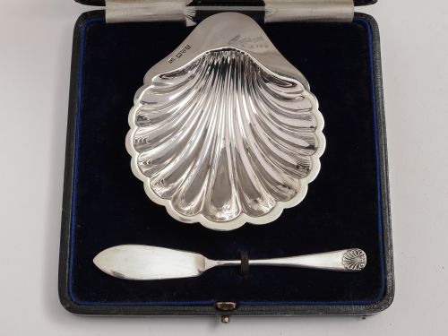 Silver shell shaped butter dish with matching knife