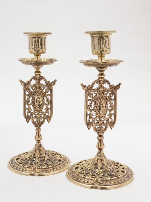 A pair of Tudor style brass candlesticks