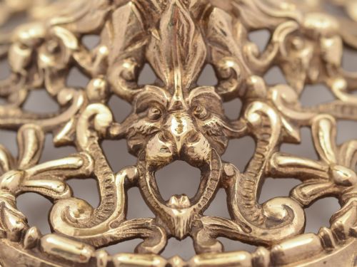 A pair of Tudor style brass candlesticks