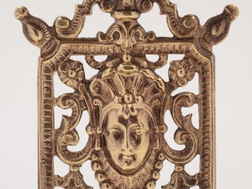 A pair of Tudor style brass candlesticks