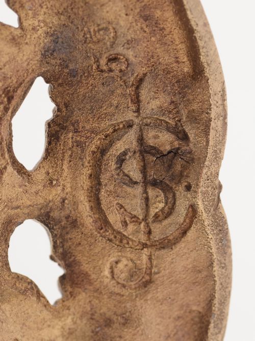 A pair of Tudor style brass candlesticks